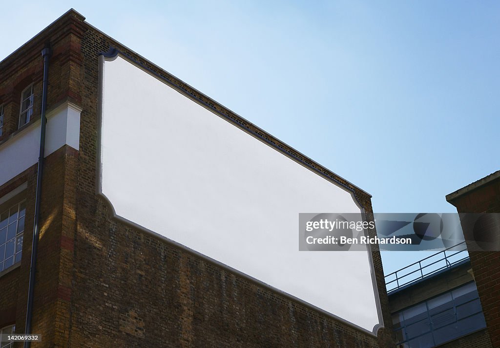 A blank old fashioned bill board on the side of a