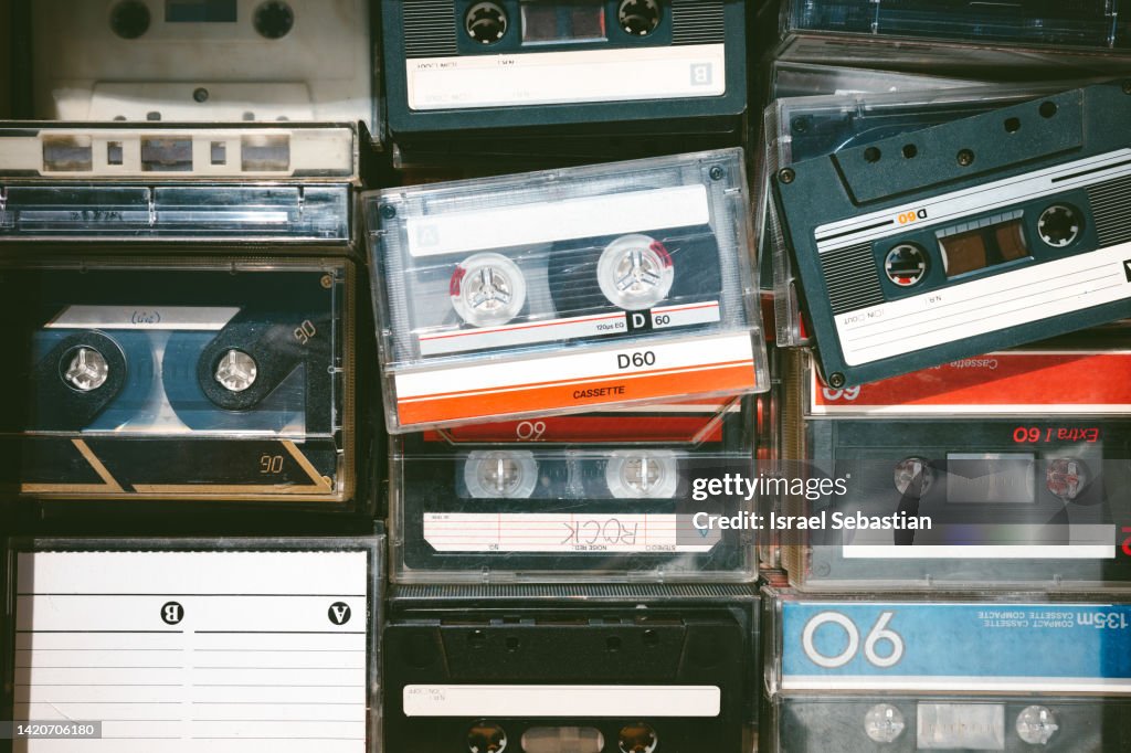 Close-up image of some old obsolete cassette tapes of different colors from above