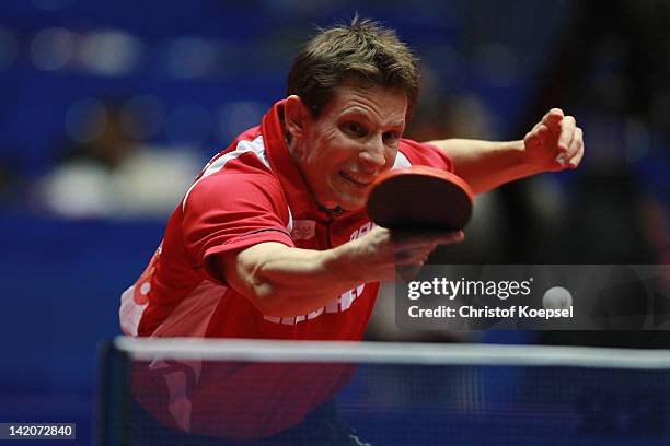 Robert Gardos of Austria plays a backhand during his match against Bartosz Such of Poland during the LIEBHERR table tennis team world cup 2012...