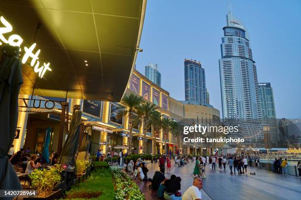 visiting the dubai mall - dubai mall stock pictures, royalty-free photos & images