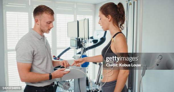 medico che fa ricerca sul fitness, laboratorio di scienze della palestra e fisioterapista che monitora l'attività fisica della sportiva nel centro sportivo. testare il benessere dell'atleta e l'esame di allenamento - medicina dello sport foto e immagini stock