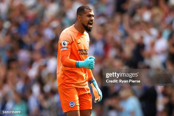 Robert Sanchez of Brighton & Hove Albion celebrates their sides first goal after Luke Thomas of Leicester City scores their sides own goal during the...