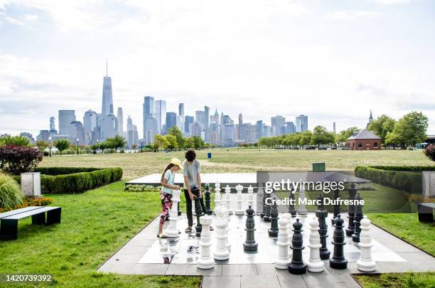 two teenagers playing chess outside - liberty state park stock pictures, royalty-free photos & images