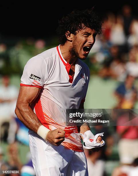 Juan Monaco of Argentina celebrates winning his match against Mardy Fish of the USA during day 11 of the Sony Ericsson Open at Crandon Park Tennis...