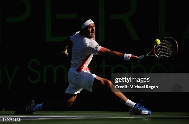 Juan Monaco of Argentina plays a shot during his match against Mardy Fish of the USA during day 11 of the Sony Ericsson Open at Crandon Park Tennis...