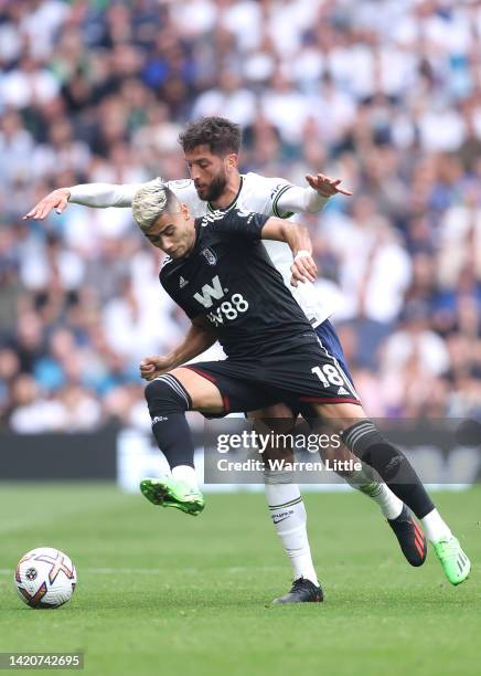 Andreas Pereira of Fulham FC is tackled by Rodrigo Bentancur of Tottenham Hotspur during the Premier League match between Tottenham Hotspur and...