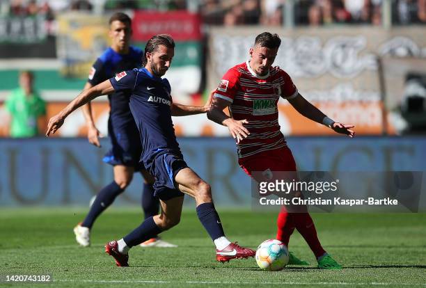 Ivan Sunjic of Hertha Berlin battles for possession with Michael Gregoritsch of Augsburg during the Bundesliga match between FC Augsburg and Hertha...