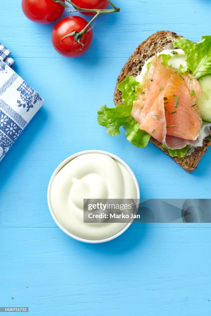 Mayonnaise and sandwich with smoked salmon, cucumber and lettuce