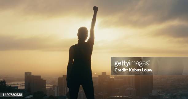 silhouette of woman for leadership, success and freedom  on mountain sunset with celebrating first for power. proud winner as inspiration for achievement, strong motivation and leader empowerment - leadership fist stock pictures, royalty-free photos & images