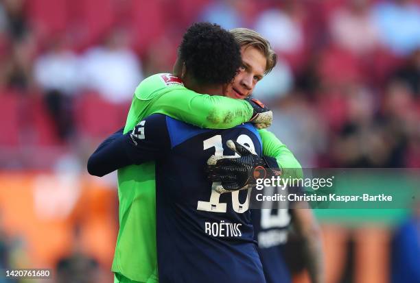 Oliver Christensen and Jean-Paul Boetius of Hertha Berlin celebrate their sides victory after the Bundesliga match between FC Augsburg and Hertha BSC...