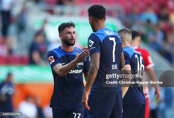 Marco Richter and Davie Selke of Hertha Berlin celebrate their sides victory after the Bundesliga match between FC Augsburg and Hertha BSC at...