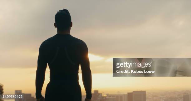 motivation, fitness and thinking man watching the sunset sky in a city after his workout. silhouette of a fit and athletic man or athlete wondering at sunrise early morning in an urban town - watching sunrise stock pictures, royalty-free photos & images