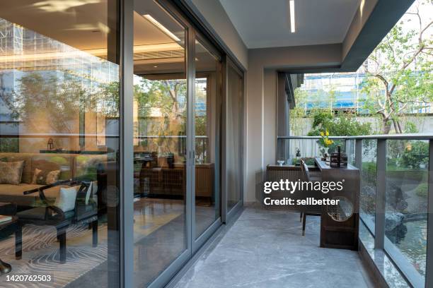 furniture on balcony - sliding door stock pictures, royalty-free photos & images