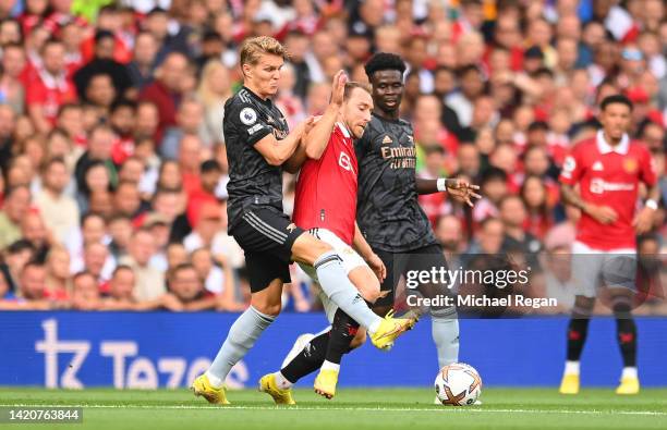 Christian Eriksen of Manchester United is fouled by Martin Oedegaard of Arsenal during the Premier League match between Manchester United and Arsenal...