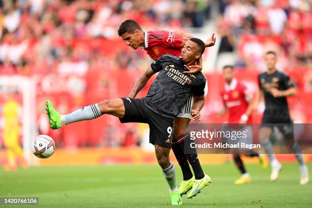 Gabriel Jesus of Arsenal battles for possession with Raphael Varane of Manchester United during the Premier League match between Manchester United...