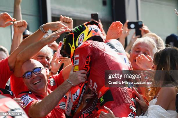 Francesco Bagnaia of Italy and Ducati Lenovo Team celebrates the victory with team under the podium at the end of the MotoGP race during the MotoGP...