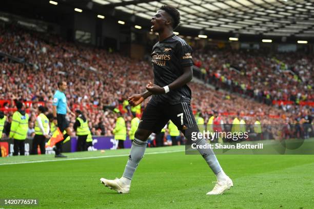 Bukayo Saka of Arsenal celebrates after scoring their sides first goal during the Premier League match between Manchester United and Arsenal FC at...
