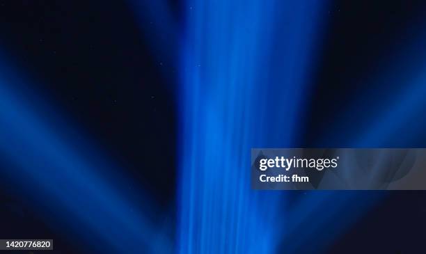 light beams in the nightsky - light saber stock pictures, royalty-free photos & images