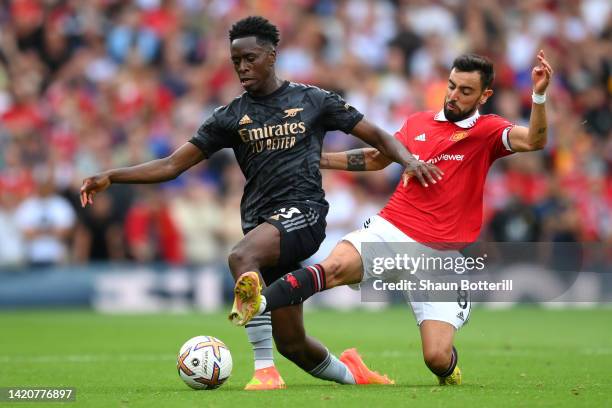 Albert Sambi Lokonga of Arsenal is tackled by Bruno Fernandes of Manchester United during the Premier League match between Manchester United and...