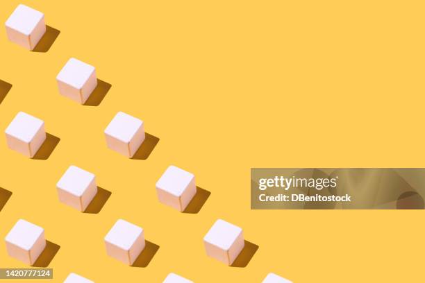white cubes pattern with hard shadow, on the left side, on yellow background. concept of geometry, futuristic, architecture, design, group of objects and many objects. - white cubes stock pictures, royalty-free photos & images