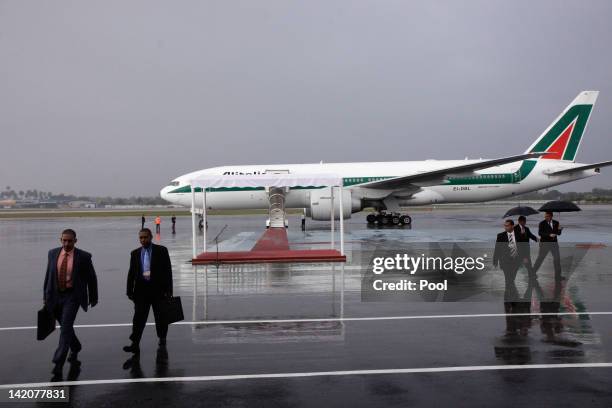 Cuban officials walk away from the plane as Pope Benedict XVI prepares to take off from Jose Marti International airport as the Pope leaves Cuba...