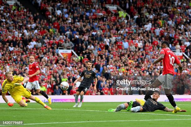 Marcus Rashford of Manchester United scores their sides third goal during the Premier League match between Manchester United and Arsenal FC at Old...