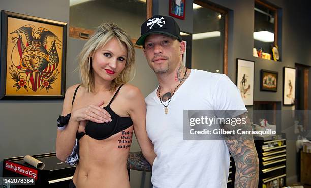 Lead singer Camilla Romestrand of the UK rock band Eddie The Gun poses with tattoo artist Ami James to promote the release of the new digital album...