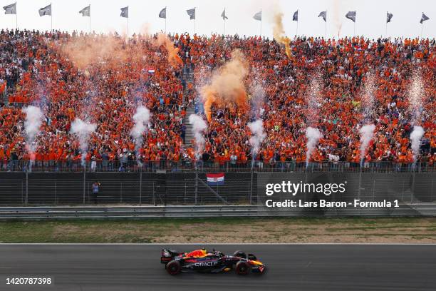 Race winner Max Verstappen of the Netherlands driving the Oracle Red Bull Racing RB18 celebrates after crossing the finish line during the F1 Grand...