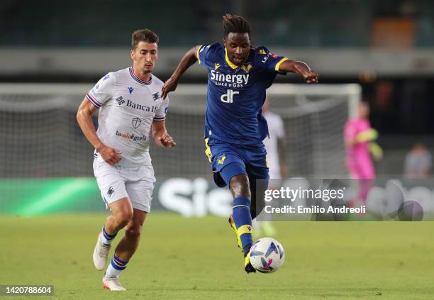 Adrien Tameze of Hellas Verona runs with the ball while under pressure from Alex Ferrari of UC Sampdoria during the Serie A match between Hellas...