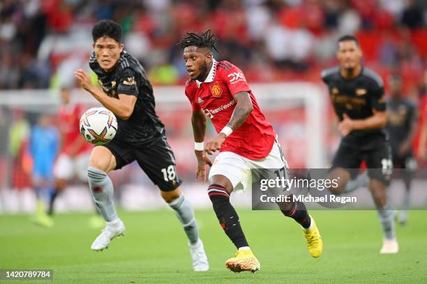Fred of Manchester United in action with Takehiro Tomiyasu of Arsenal during the Premier League match between Manchester United and Arsenal FC at Old...