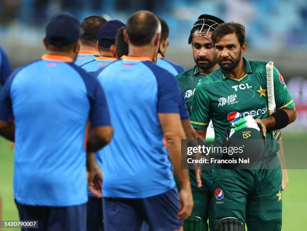 Iftikhar Ahmed of Pakistan and Khushdil Shah of Pakistan shake hand with India players after winning the DP World Asia Cup match between India and...