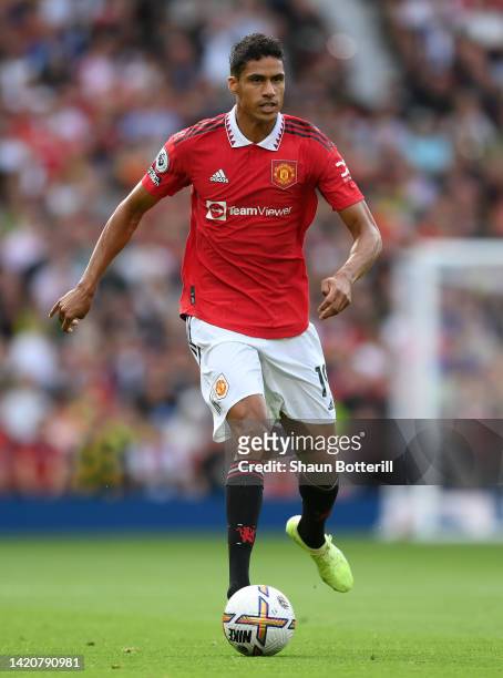 Raphael Varane of Manchester United runs with the ball during the Premier League match between Manchester United and Arsenal FC at Old Trafford on...