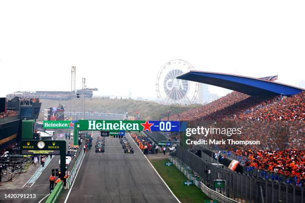 General view of Max Verstappen of the Netherlands driving the Oracle Red Bull Racing RB18, Charles Leclerc of Monaco driving the Ferrari F1-75 and...