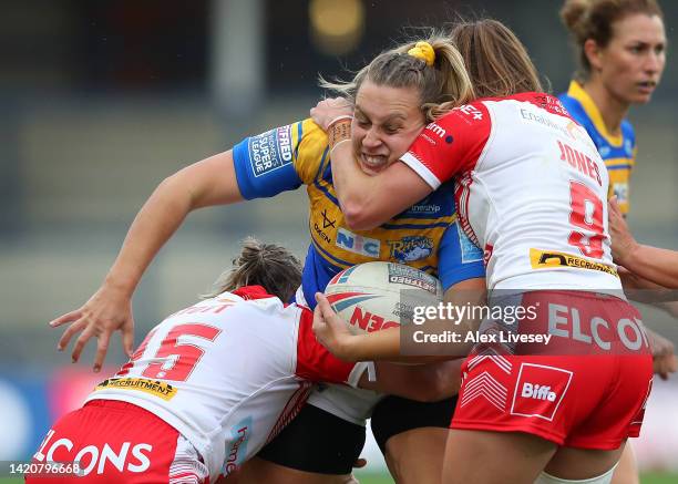 Chloe Kerrigan of Leeds Rhinos is tackled by Tara Jones and Bethany Stott of St Helens during the Betfred Women's Super League Semi Final match...