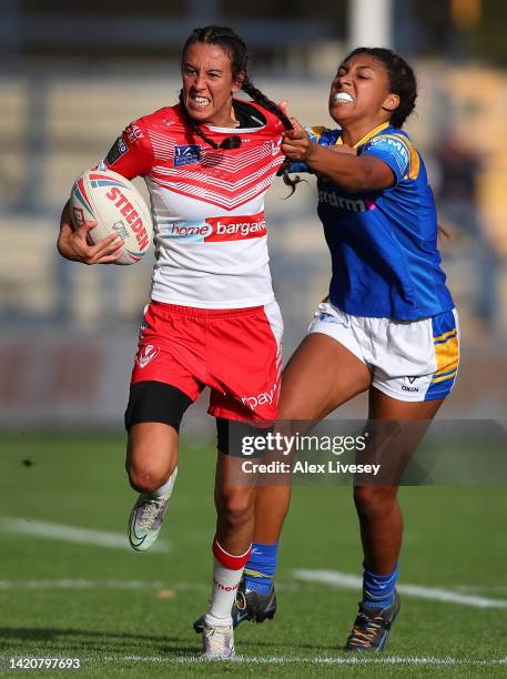 Zoe Harris of St Helens is tackled by Sophie Robinso of Leeds Rhinos during the Betfred Women's Super League Semi Final match between St Helens and...