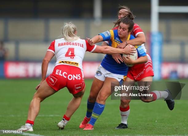 Samantha Hulme of Leeds Rhinos is tackled by Amy Hardcastle and Bethany Stott of St Helens during the Betfred Women's Super League Semi Final match...
