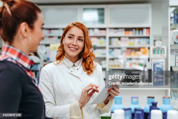 pharmacist talking to customer about medicine - pharmacist stock pictures, royalty-free photos & images