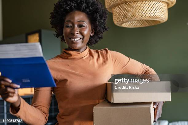 young woman reading a thank you letter - loyalty program stock pictures, royalty-free photos & images