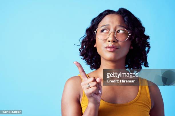confused woman, thinking direction and studio mockup background. pensive, annoyed or curious person contemplating decision. girl with solution or idea pointing for marketing advertisement. - no idea stock pictures, royalty-free photos & images