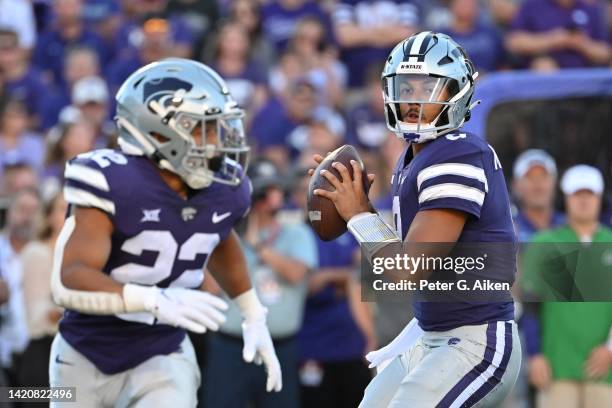 Quarterback Adrian Martinez of the Kansas State Wildcats hands throws a pass to running back Deuce Vaughn during the first half against the South...