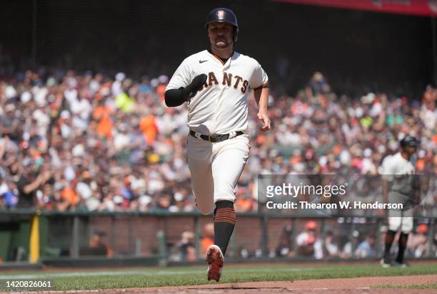 Davis of the San Francisco Giants scores on an RBI single off the bat of LaMonte Wade Jr. Against the Philadelphia Phillies in the bottom of the...