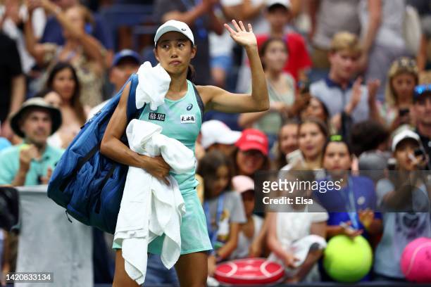 Shuai Zhang of China waves as she leaves the court following her loss against Coco Gauff of the United States during their Women's Singles Fourth...