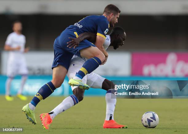 Thomas Henry of Hellas Verona competes for the ball with Omar Colley of UC Sampdoria during the Serie A match between Hellas Verona and UC Sampdoria...