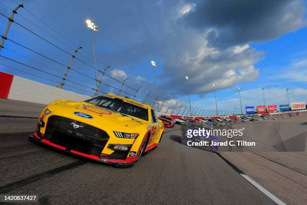 Joey Logano, driver of the Shell Pennzoil Ford, and Christopher Bell, driver of the Yahoo! Toyota, lead the field on a pace lap prior to the NASCAR...