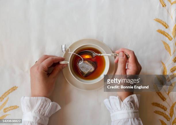 quiet tea time - stirring stock pictures, royalty-free photos & images