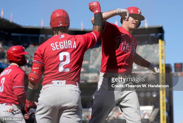 Realmuto of the Philadelphia Phillies celebrates his three-run home run with Jean Segura against the San Francisco Giants in the top of the eighth...