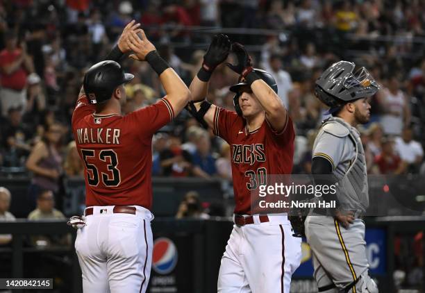 Jake McCarthy of the Arizona Diamondbacks celebrates his two-run home run with Christian Walker against the Milwaukee Brewers during the eighth...