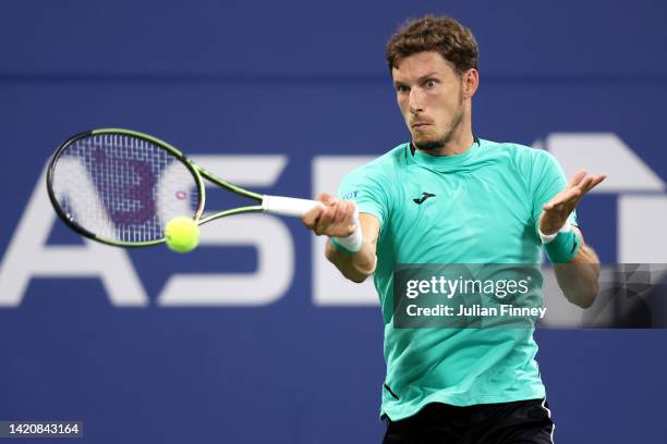 Pablo Carreno Busta of Spain returns a shot against Karen Khachanov of Russia during their Men's Singles Fourth Round match on Day Seven of the 2022...