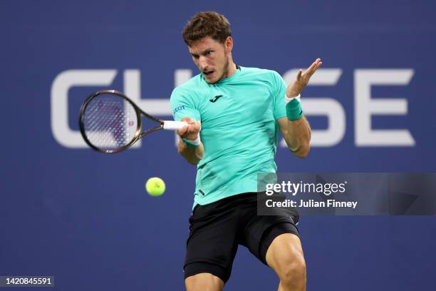 Pablo Carreno Busta of Spain returns a shot against Karen Khachanov of Russia during their Men's Singles Fourth Round match on Day Seven of the 2022...