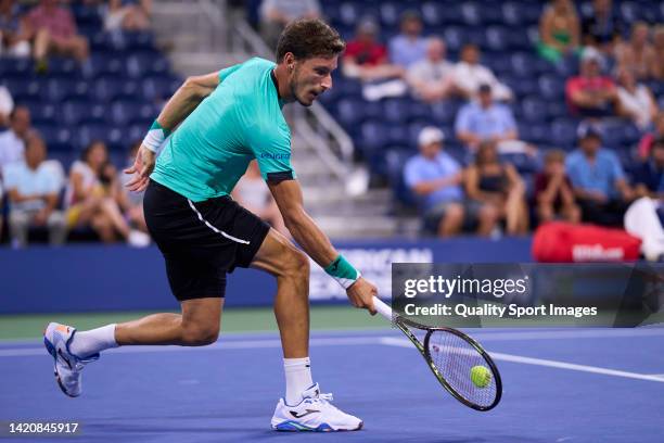 Pablo Carreno of Spain returns a ball to Karen Khachanov of Russia during their Men's Singles Fourth Round match on Day Seven of the 2022 US Open at...